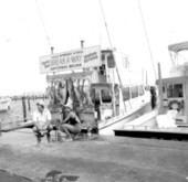 A couple poses with displayed fish of a charter boat - Destin, Florida