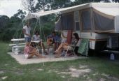 People picnicking near camper at St. Andrews State Park - Panama City, Florida..