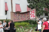 Gun-control activists with their sign at the Old Capitol during the Never Again Rally in Tallahassee.