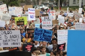 Close-up view showing student demonstrators with their signs at the Never Again Rally in Tallahassee.