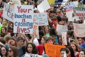 Close-up view showing student demonstrators with their signs at the Never Again Rally in Tallahassee.