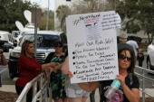 Gun-control activist holding up her sign at the Never Again Rally in Tallahassee.