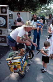 "Iguana Man" John W. Meek allowing small boy to hold his pet - Key West, Florida.