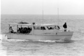 Boat loaded with Cuban refugees arriving in Key West during the Mariel Boatlift.