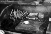 Cigars and materials used in creating them on a work station desk top inside "Rex of Key West" cigar factory.