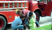 Key West Fire Department members connecting hard suction hose to fire hydrant - Key West, Florida.