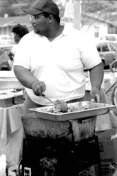 Jamaican American man cooking Jamaican food at Zora Neale Hurston Festival- Eatonville, Florida