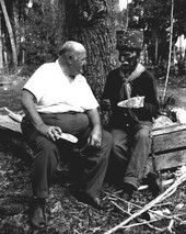 Billy Bowlegs III telling Albert DeVane where he found ancient Indian artifacts while preparing to plant his garden