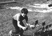 Boy lifting forks with fish during mullet roast - Monticello, Florida