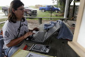 Leoma Simmons using a laptop computer for ranching operations at the Big Cypress Seminole Indian Reservation in Hendry County, Florida.