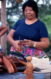 Mary Billie cutting cardboard for the Seminole doll she is making - Big Cypress Reservation, Florida