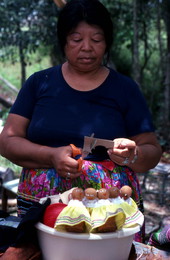 Mary Billie cutting cardboard to make hair for her Seminole dolls - Big Cypress Reservation, Florida