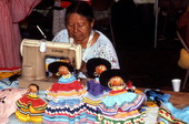 Seminole woman Annie Jimmie sewing, with examples of Seminole dolls - White Springs, Florida