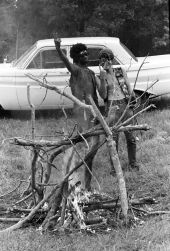 Young men at the 1970 Florida Folk Festival giving the peace/victory sign - White Springs, Florida.