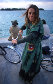 Portrait of a woman with her bike at the Sunset Celebration at Mallory Square in Key West.