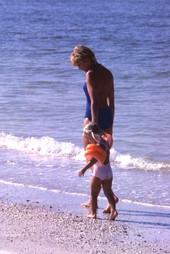 Mother walking with daughter along the seashore in Sarasota.