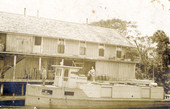 Postcard showing the Koreshan Unity boat "The Estero" docked by the old store.