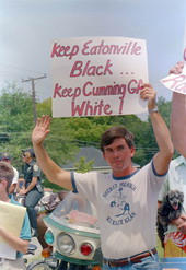 Klansman John Baumgardner holds a sign at the Parade - Eatonville, Florida