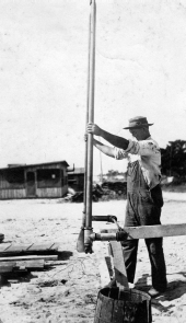 Construction worker with a cutting tool in the Everglades Drainage District.