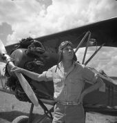 Bill Tankersley from the NYA's Camp Roosevelt posing in front of an airplane - Ocala, Florida.