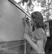 Painting logo on truck at the NYA's Camp Roosevelt - Ocala, Florida.