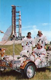 Apollo 17 astronauts posing with a lunar roving vehicle at the Kennedy Space Center.