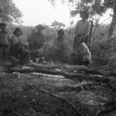 Six people on a cattle roundup waiting by the campfire for coffee