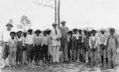 Alec Smith and others posing with child caddies in Miami, Florida.