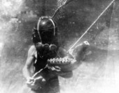 Diver holding lower jaw of mastodon