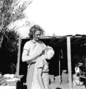 Migrant worker cleaning her daughter's scalp - Belle Glade, Florida.