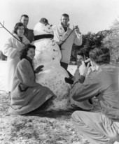 Florida State University students gathered around their snowman for a portrait - Tallahassee, Florida.