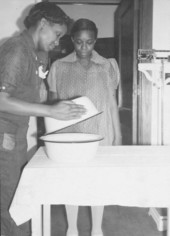 Certified nurse midwife showing helper how to remove cover from the boiled cotton for delivery.