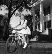 Darby Collins, daughter of Governor Collins, riding her new Christmas gift at "The Grove" in Tallahassee, Florida.