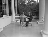 Governor LeRoy Collins and Mrs. Collins sitting on the porch at their home "The Grove" in Tallahassee.