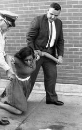 Patricia Stephens Due being arrested after defying restraining order with others at the State Theatre in Tallahassee.