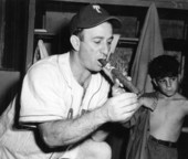 Manager of the minor League Tampa Smokers, Tony Cuccinello, lighting a cigar - Tampa, Florida.