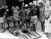 Boys look at an exhibit while standing on the tread of a crawler-transporter - Cape Canaveral Florida