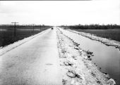 A car running down the Tamiami Trail by canal - Everglades, Florida